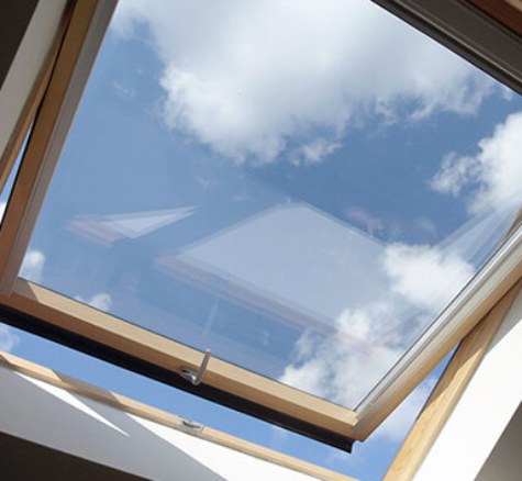 Open timber-framed roof window viewed from indoors