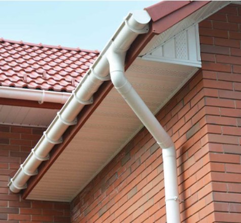 White guttering and downpipe installed on a brick house